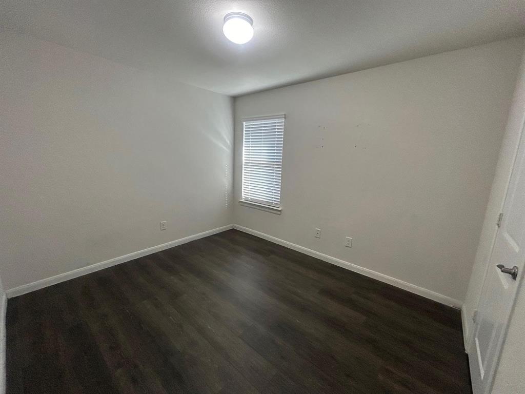 602 Range Drive Princeton, TX 75407 - Photo 14 of 19 an empty room with wooden floor and windows