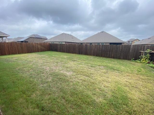 602 Range Drive Princeton, TX 75407 - Photo 19 of 19 a view of a backyard with wooden fence