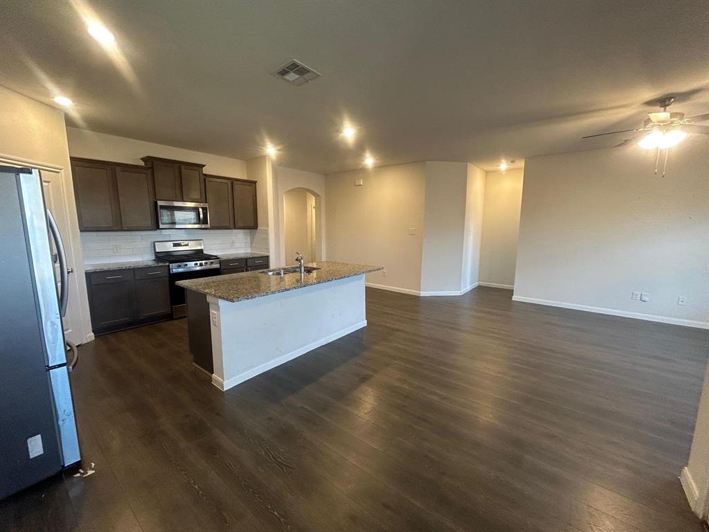 602 Range Drive Princeton, TX 75407 - Photo 3 of 19 a kitchen with stainless steel appliances granite countertop a stove a sink and a refrigerator