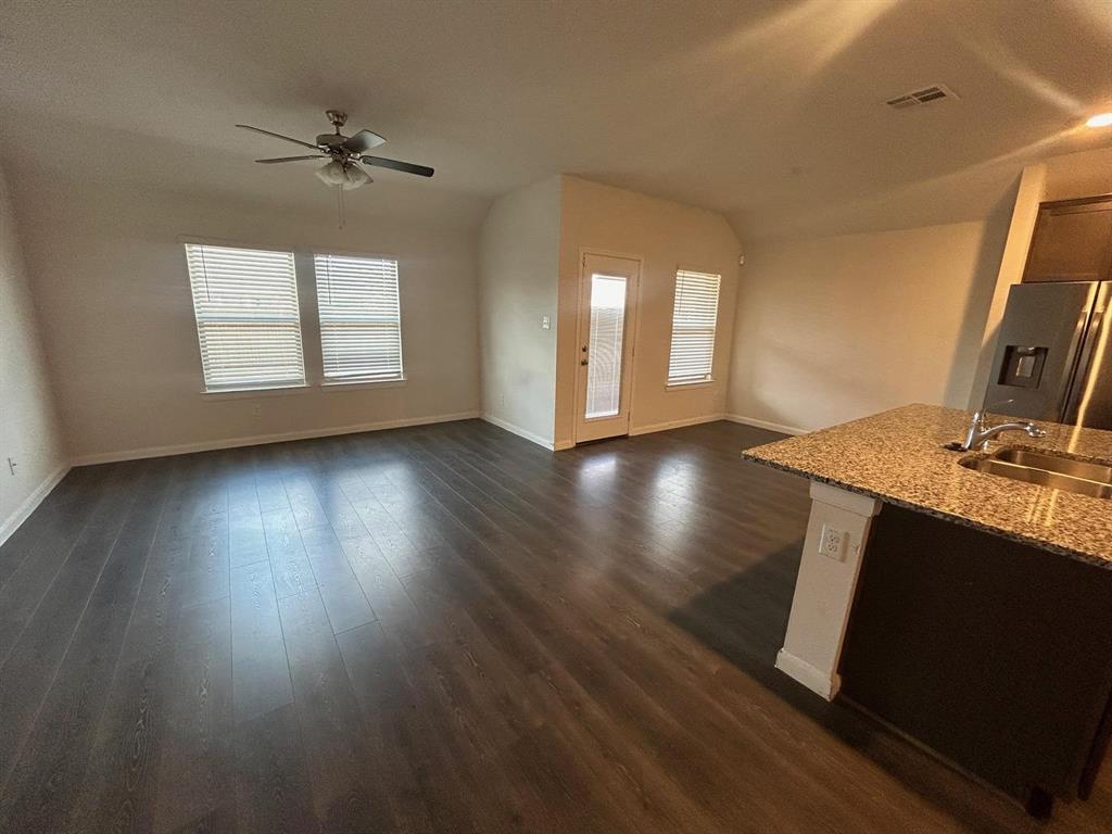 602 Range Drive Princeton, TX 75407 - Photo 6 of 19 a view of empty room with wooden floor and fan