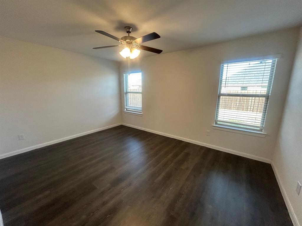 602 Range Drive Princeton, TX 75407 - Photo 8 of 19 a view of an empty room with wooden floor and a window