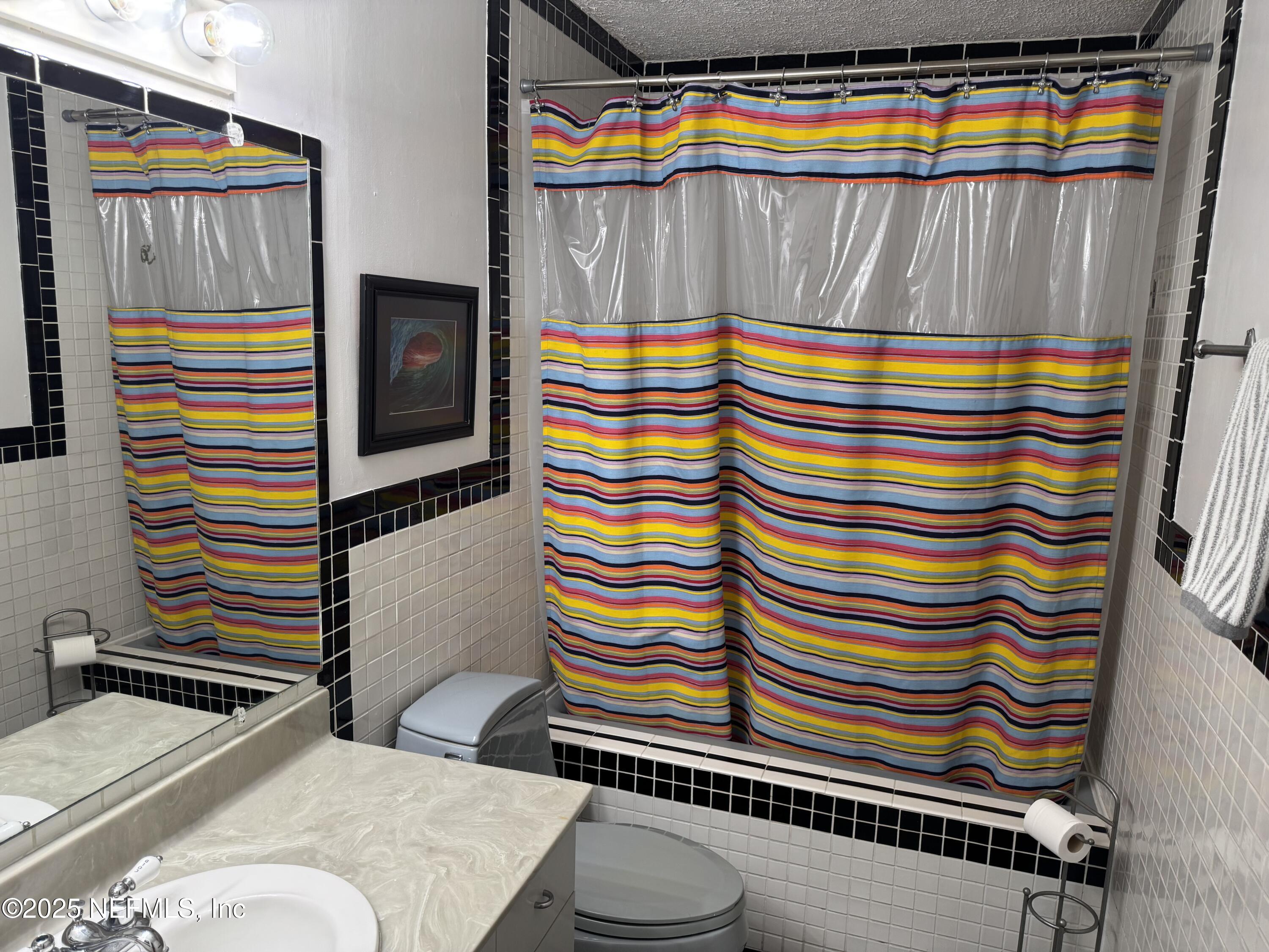 2233 Seminole Road, Unit 33 Atlantic Beach, FL 32233 - Photo 11 of 14 a bathroom with a sink and a mirror