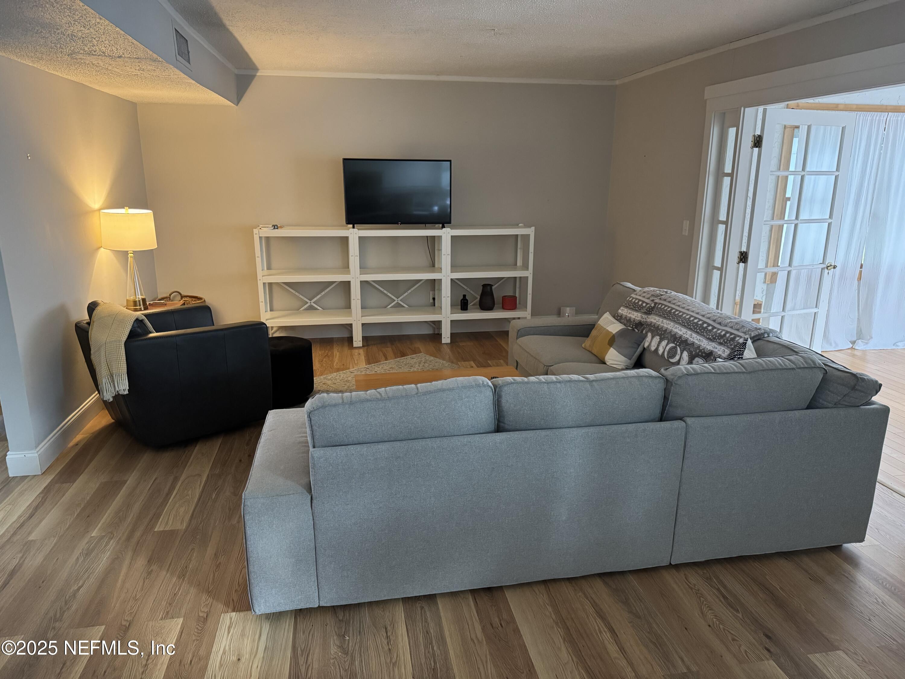 2233 Seminole Road, Unit 33 Atlantic Beach, FL 32233 - Photo 2 of 14 a living room with furniture and a flat screen tv