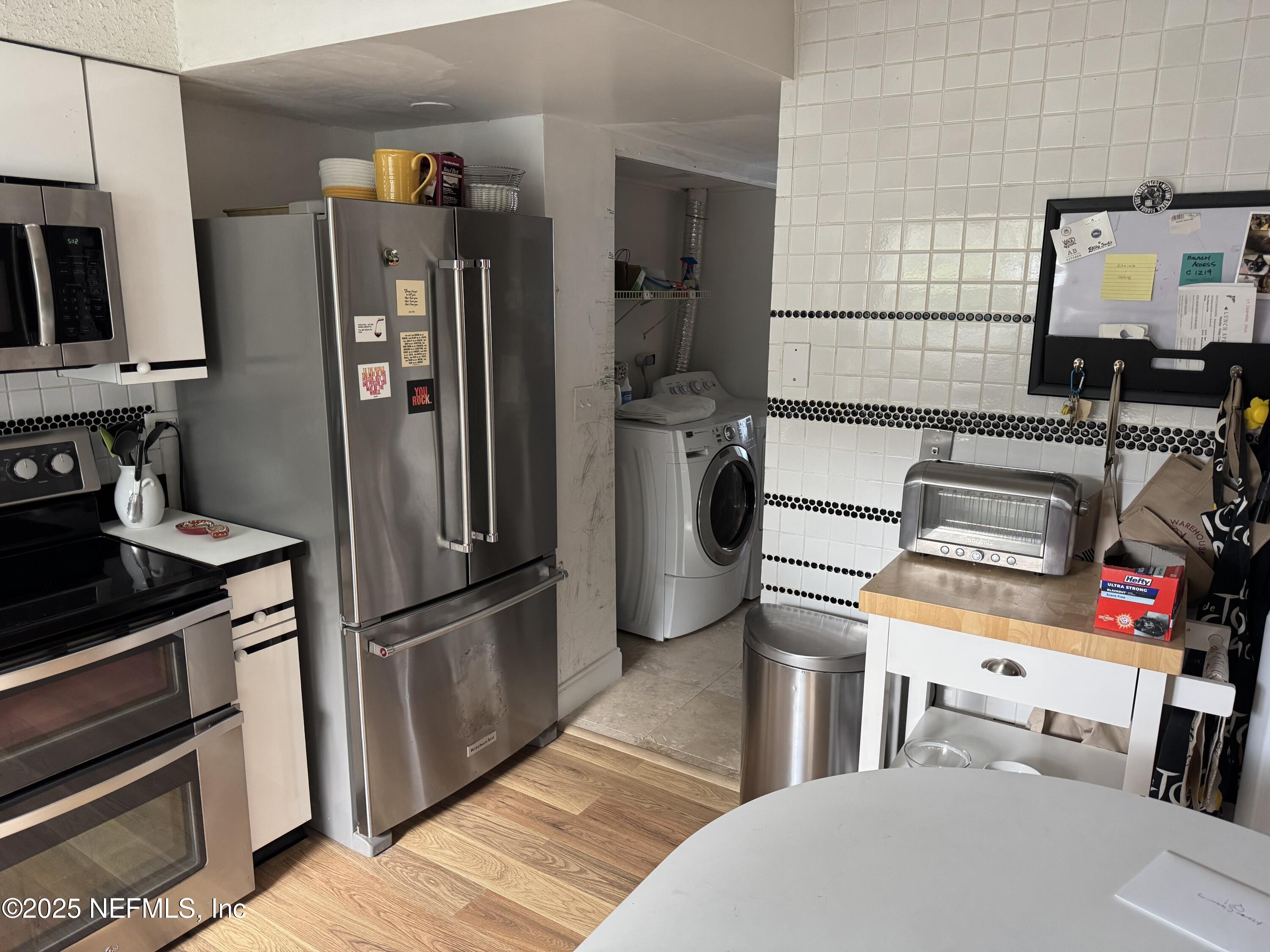 2233 Seminole Road, Unit 33 Atlantic Beach, FL 32233 - Photo 4 of 14 a kitchen with stainless steel appliances granite countertop a refrigerator and a stove top oven