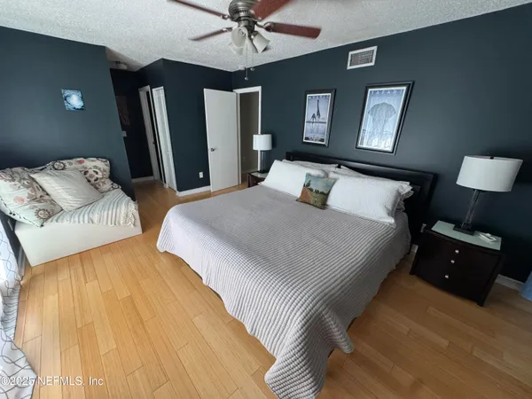 a bedroom with double bed and a chandelier