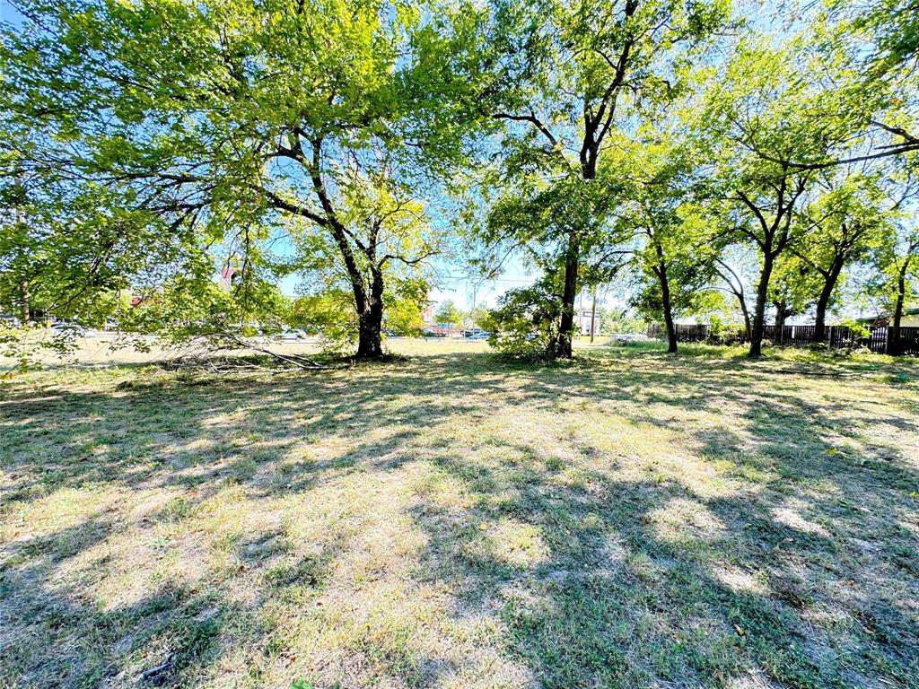 6514 South Cooper Street Arlington, TX 76001 - Photo 2 of 6 a view of a field with trees in the background