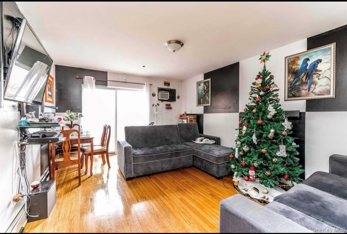 35-43 97th Street Queens, NY 11368 - Photo 4 of 10 a living room with furniture plant and a window