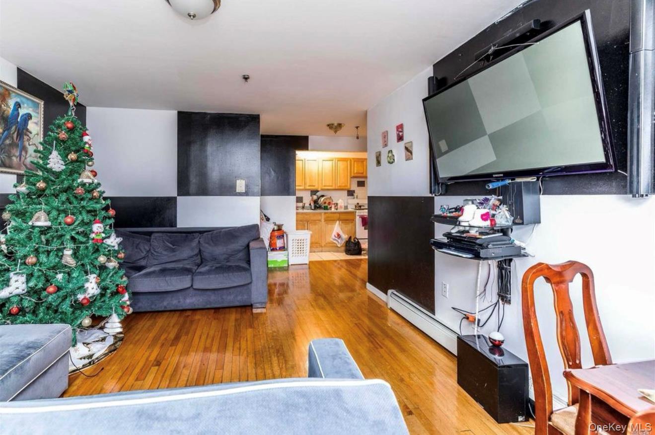 35-43 97th Street Queens, NY 11368 - Photo 5 of 10 a living room with furniture and a flat screen tv