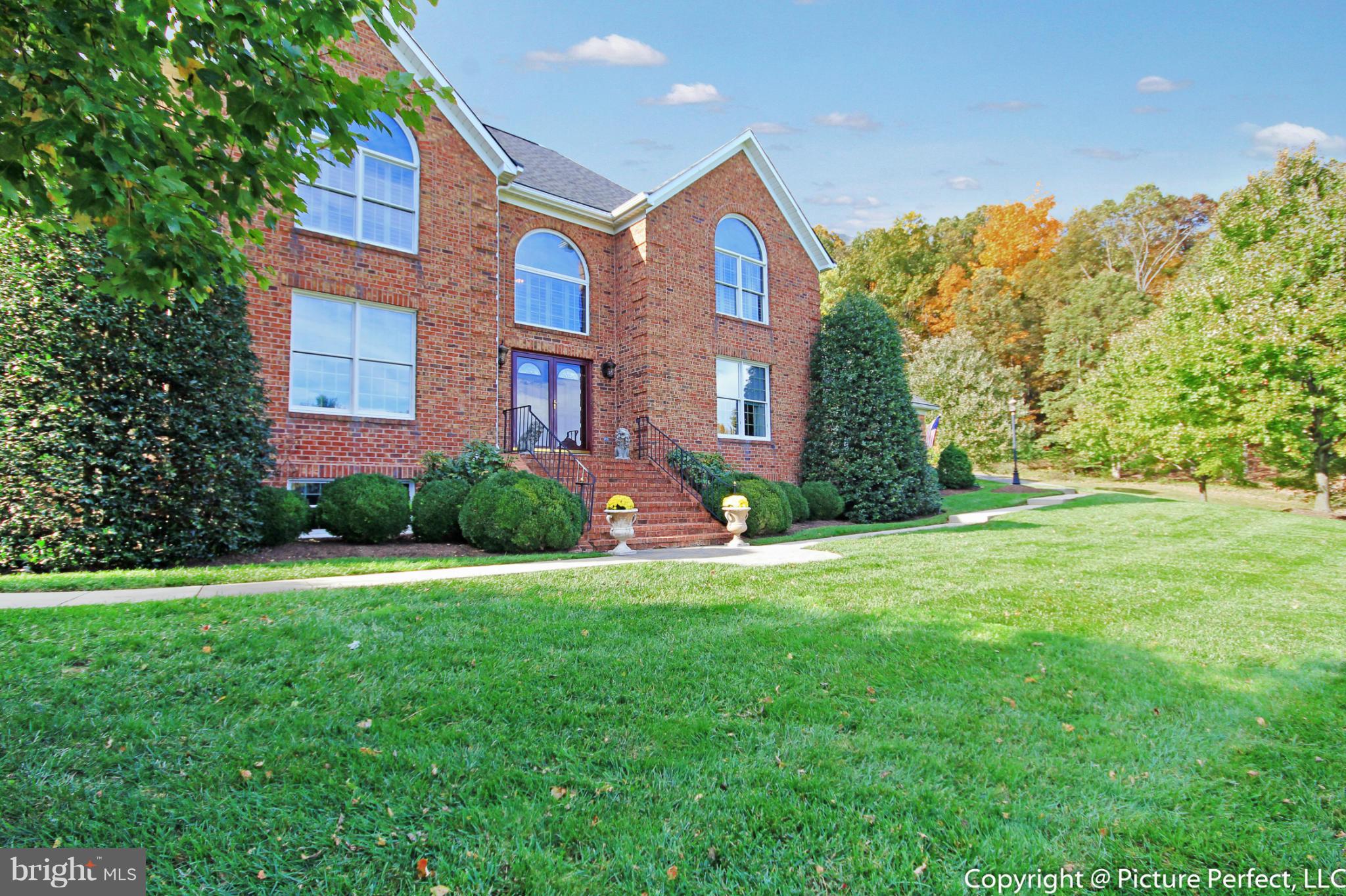 5380 Stone Road Frederick, MD 21703 - Photo 1 of 30 a front view of a house with a yard and trees