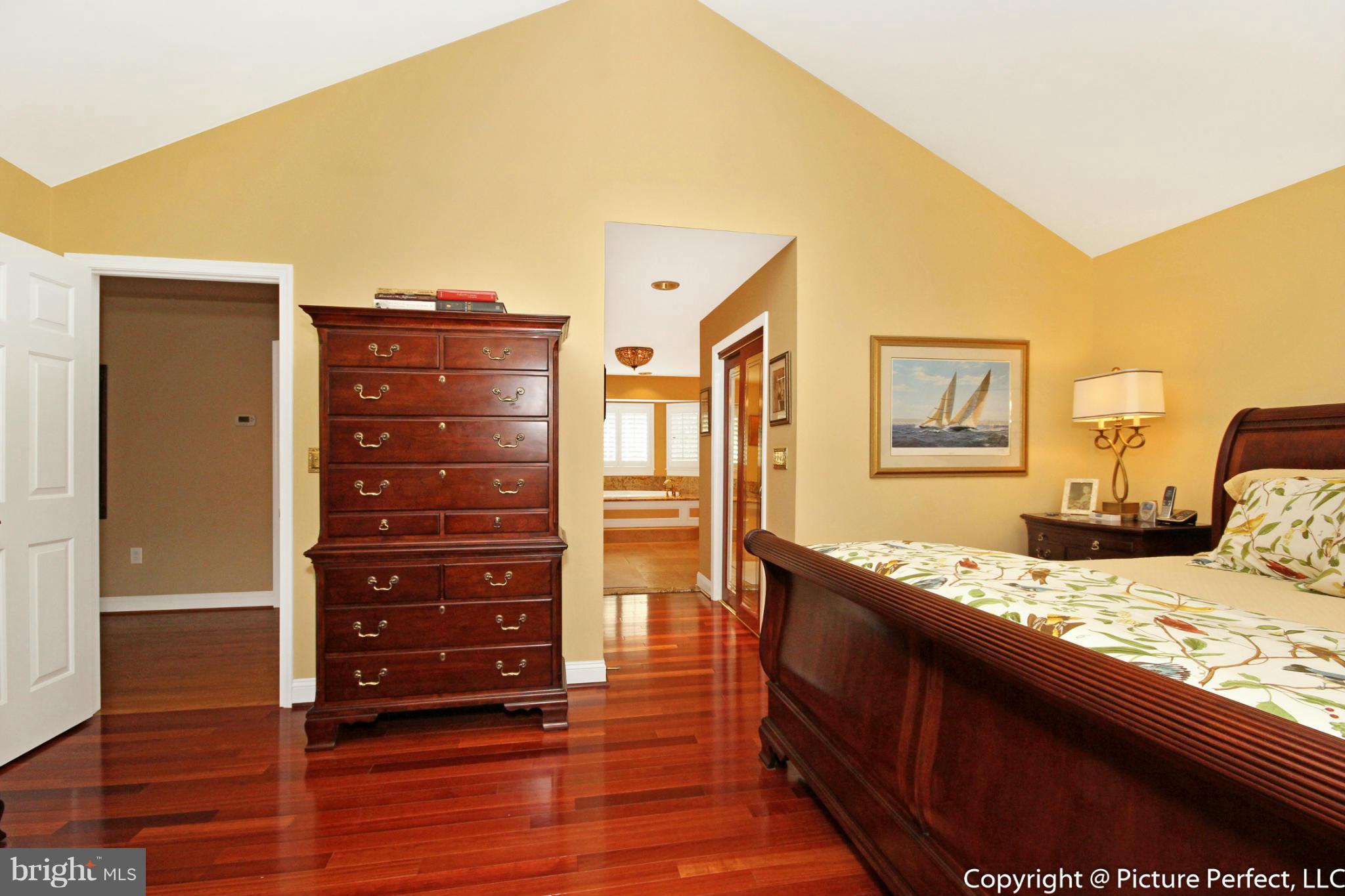 5380 Stone Road Frederick, MD 21703 - Photo 21 of 30 a bedroom with a bed and wooden floor