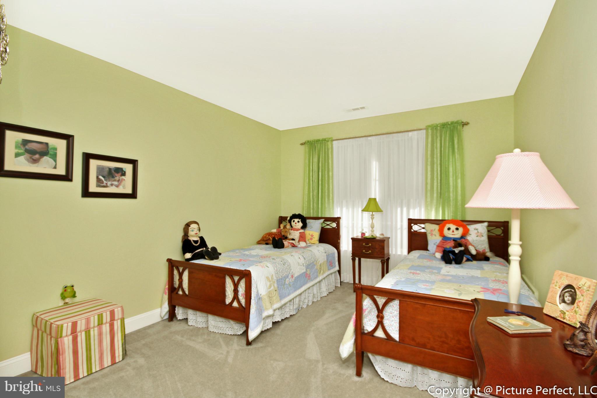 5380 Stone Road Frederick, MD 21703 - Photo 25 of 30 a bedroom with a bed and a lamp on table