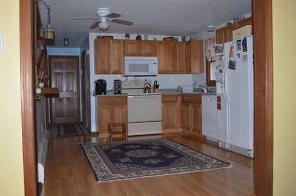 12 Old Battery Road Townsend, MA 01474 - Photo 2 of 3 a kitchen with stainless steel appliances granite countertop a refrigerator and a stove top oven