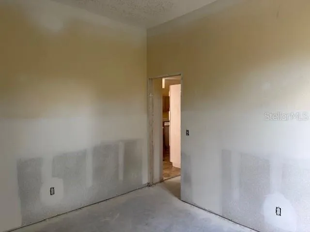 a view of a backyard with a large window and wooden floor