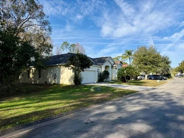 a front view of a house with a yard and a garage
