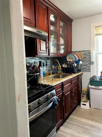 a kitchen with wooden cabinets and a stove top oven