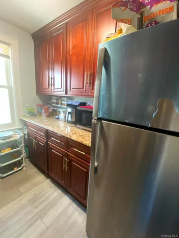 a kitchen with stainless steel appliances granite countertop a refrigerator a sink and a stove