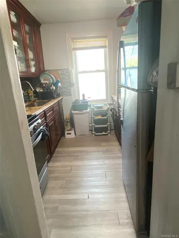 a kitchen with stainless steel appliances granite countertop a refrigerator a stove a sink and dishwasher