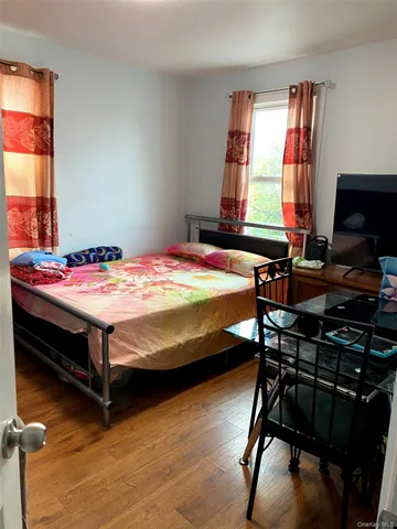 a bedroom that has a bed and a table in it