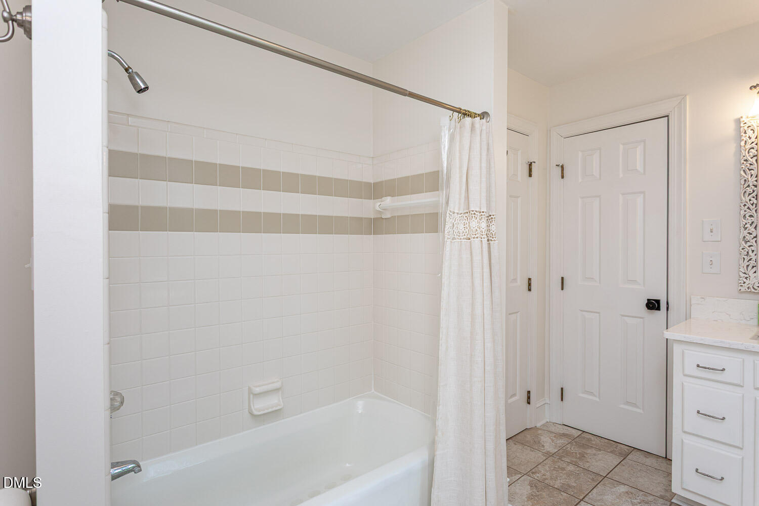 8509 Towneley Place Raleigh, NC 27615 - Photo 25 of 36 a bathroom with a bathtub and a shower