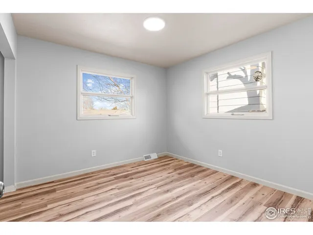 a view of bedroom with wooden floor
