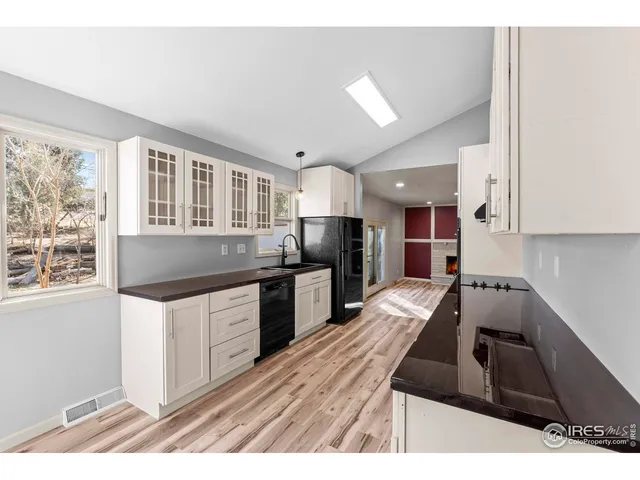 a kitchen that has a sink and a stove