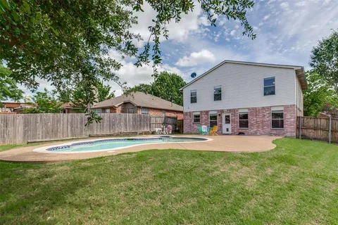 a house view with a sitting space and garden