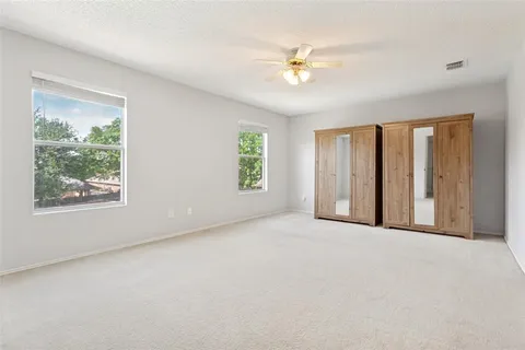 a view of an empty room with windows