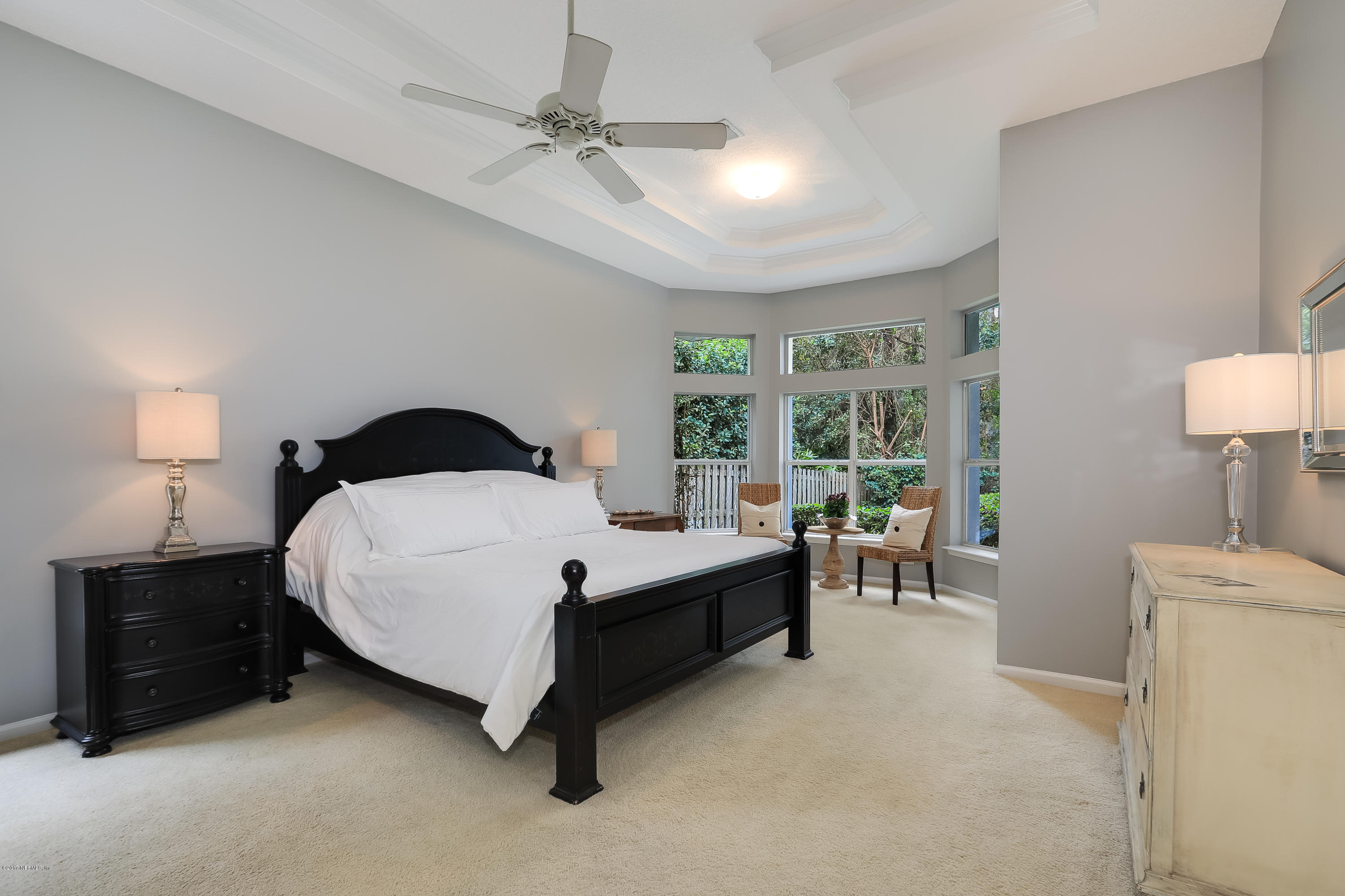 489 Big Tree Road Ponte Vedra Beach, FL 32082 - Photo 14 of 32 a spacious bedroom with a bed and a lamp on table