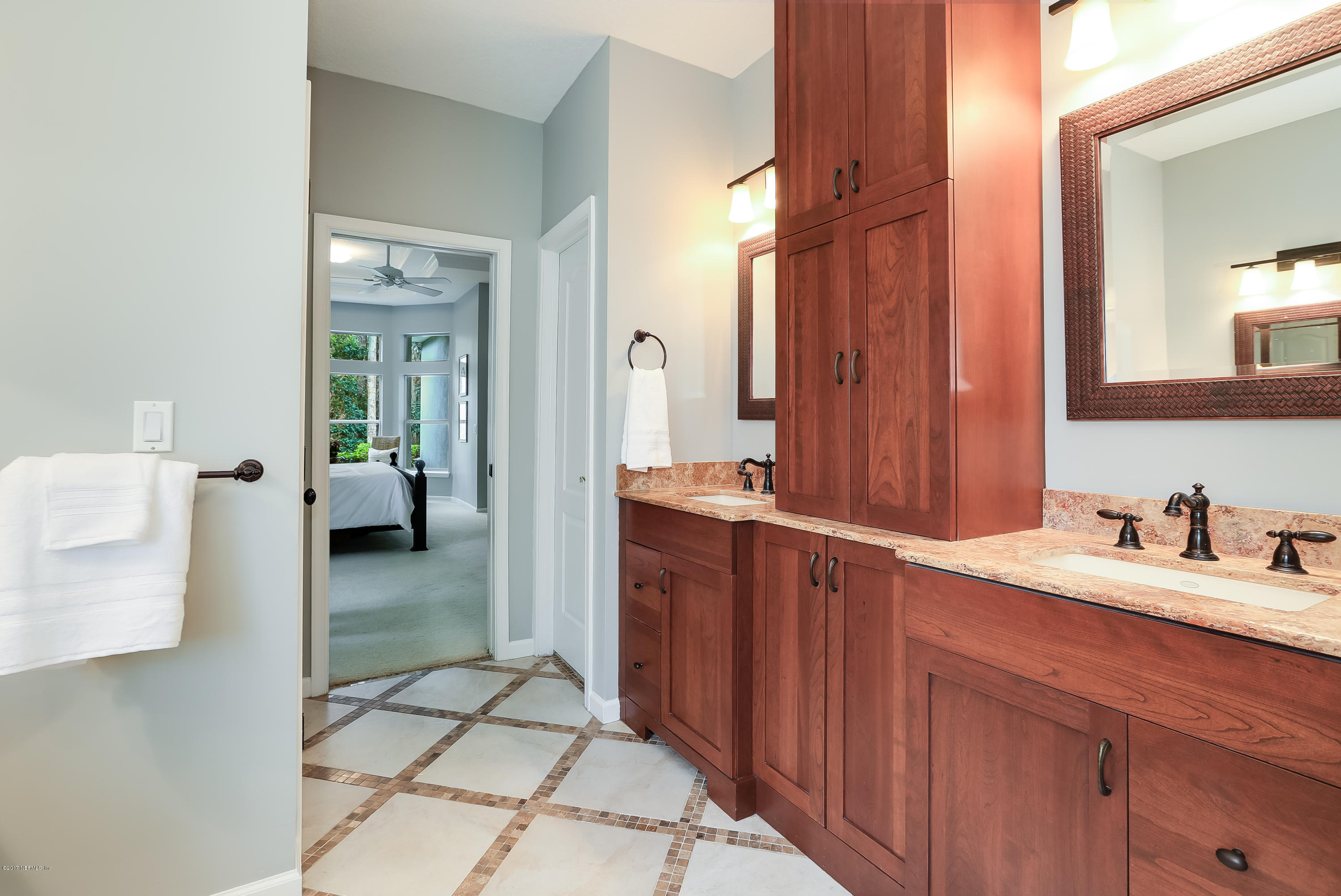 489 Big Tree Road Ponte Vedra Beach, FL 32082 - Photo 16 of 32 a en suite bathroom with a granite countertop sink and a mirror