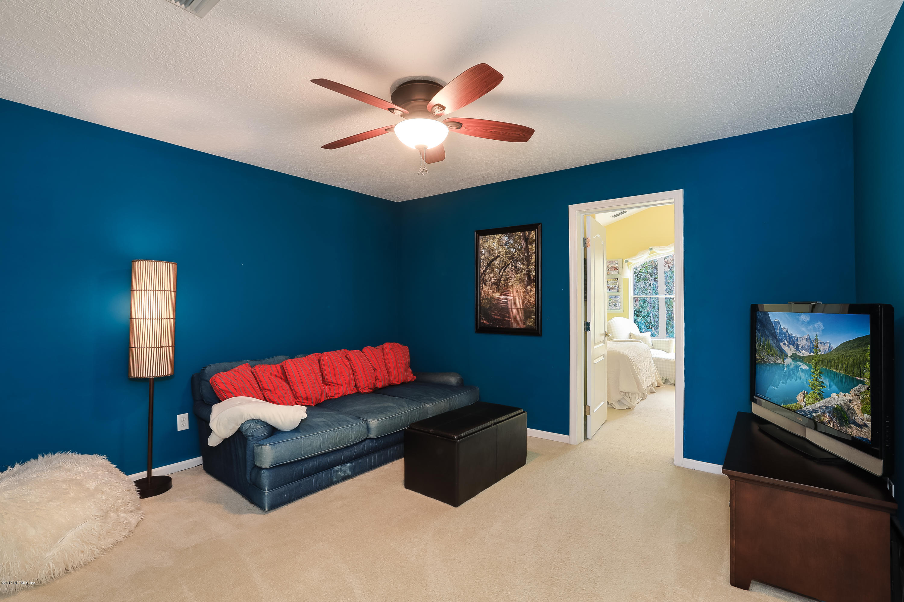 489 Big Tree Road Ponte Vedra Beach, FL 32082 - Photo 20 of 32 a living room with furniture and a flat screen tv