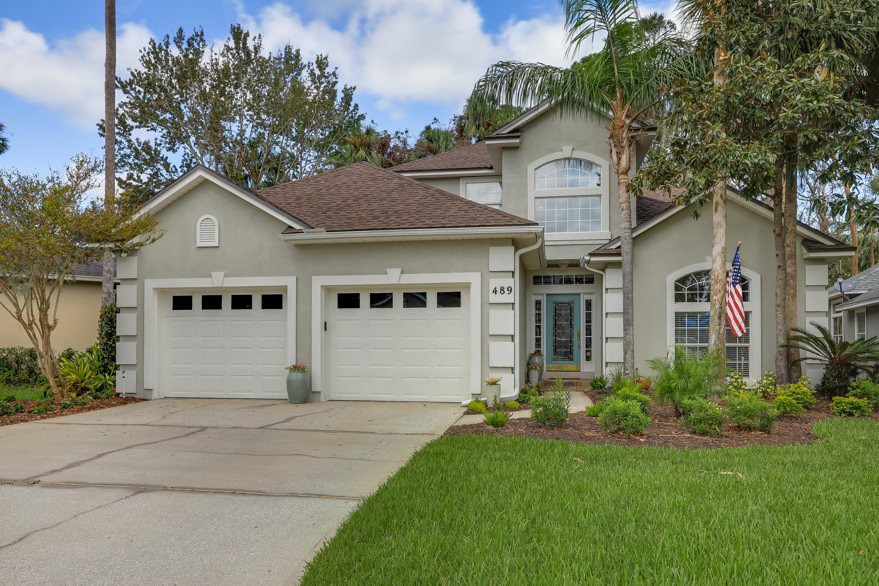 489 Big Tree Road Ponte Vedra Beach, FL 32082 - Photo 2 of 32 a front view of a house with a garden and plants