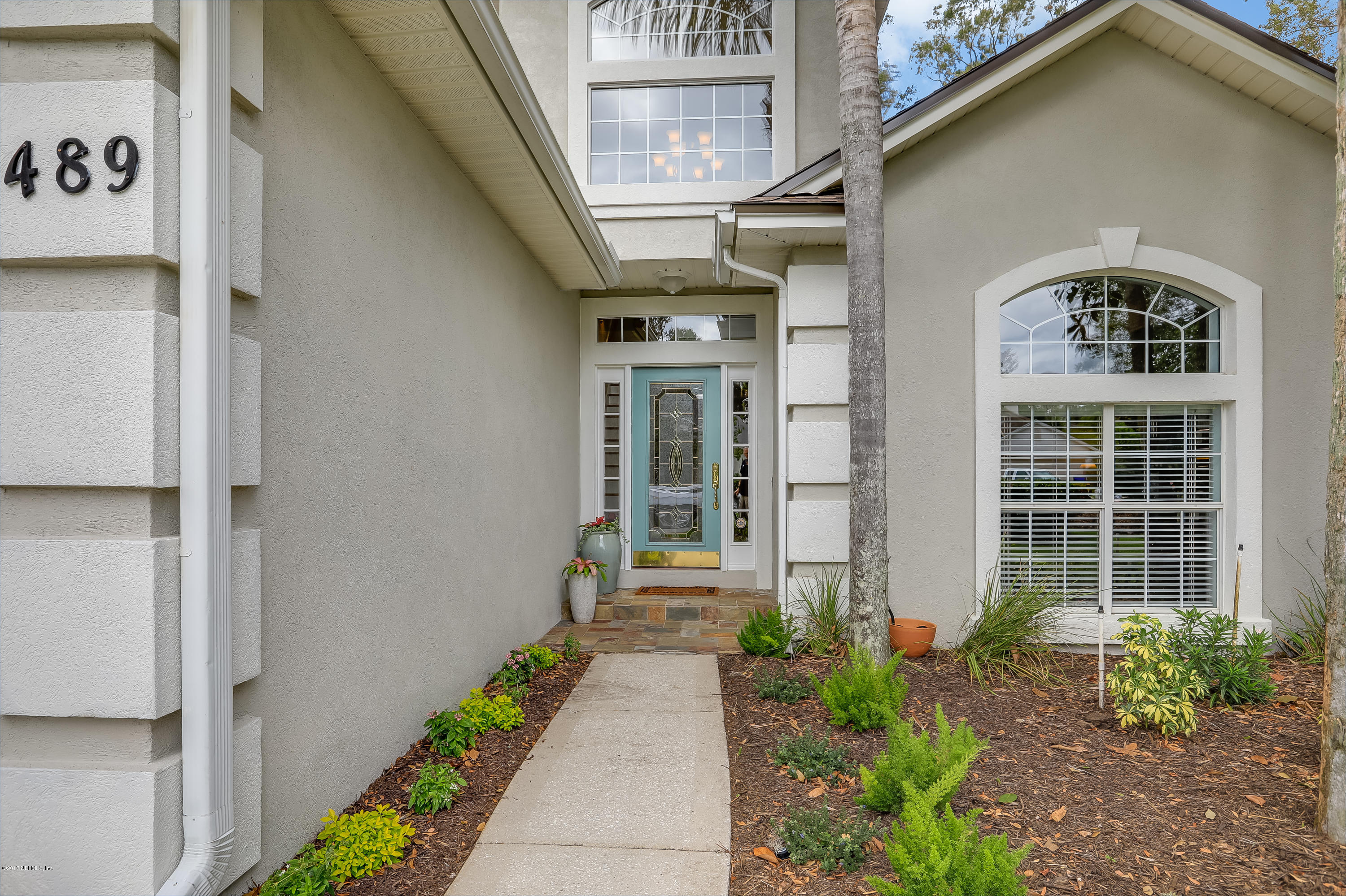 489 Big Tree Road Ponte Vedra Beach, FL 32082 - Photo 3 of 32 a front view of a house with a yard