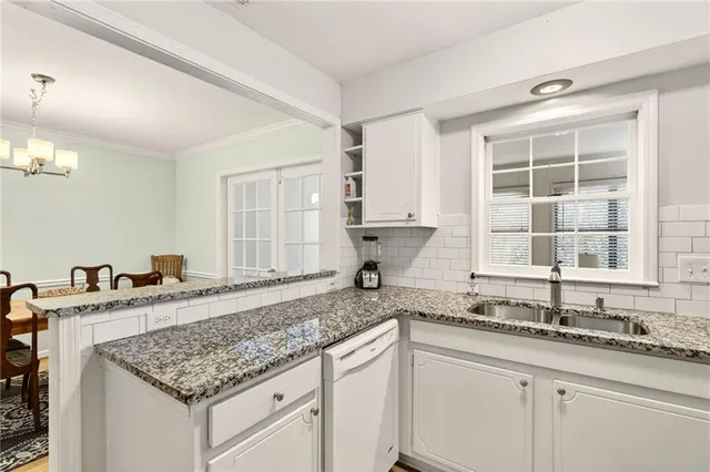a kitchen with granite countertop a sink and a window