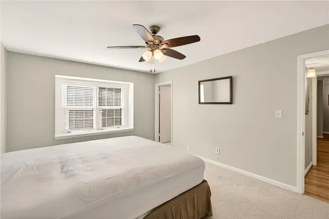 a bedroom with a large bed and a window