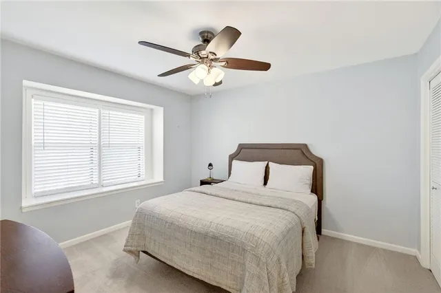 a bedroom with a large bed and a window