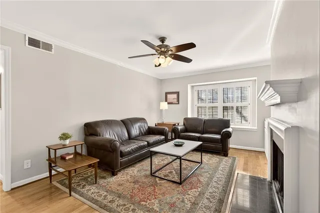a living room with furniture a fireplace and a window