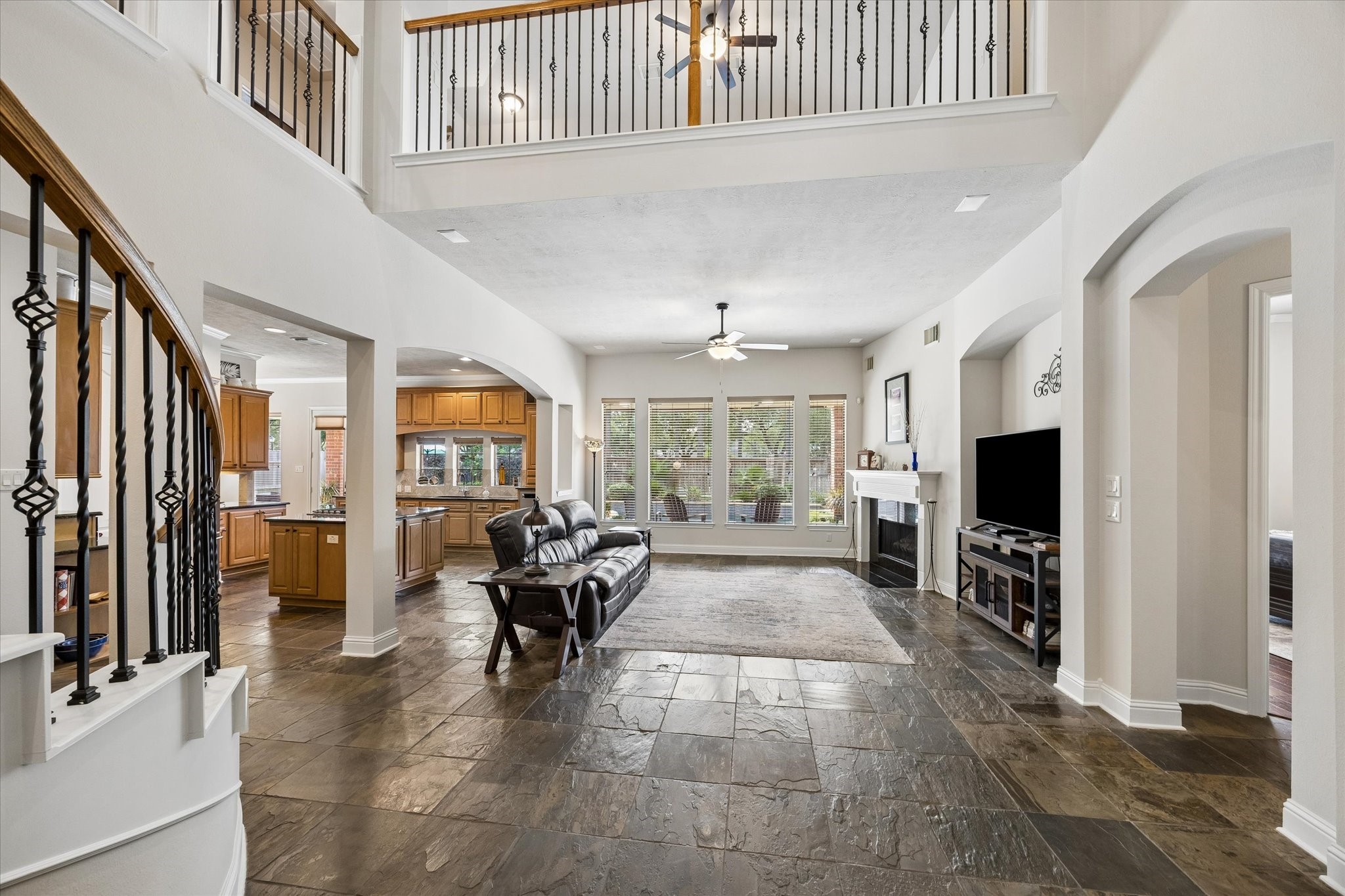 3902 Trailstone Lane Katy, TX 77494 - Photo 11 of 50 This inviting family room is ready for everyday living and easy entertaining with slate tile flooring, a gas-log fireplace, and an open connection to the kitchen that keeps everyone close.