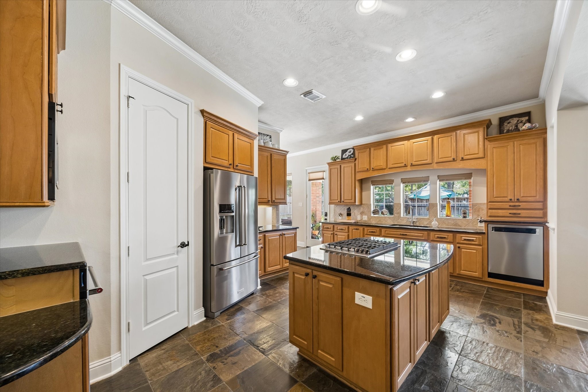3902 Trailstone Lane Katy, TX 77494 - Photo 15 of 50 Show off your culinary skills in this beautifully designed kitchen with granite countertops, stainless steel appliances, a walk-in pantry, and enough space to feed a crowd.