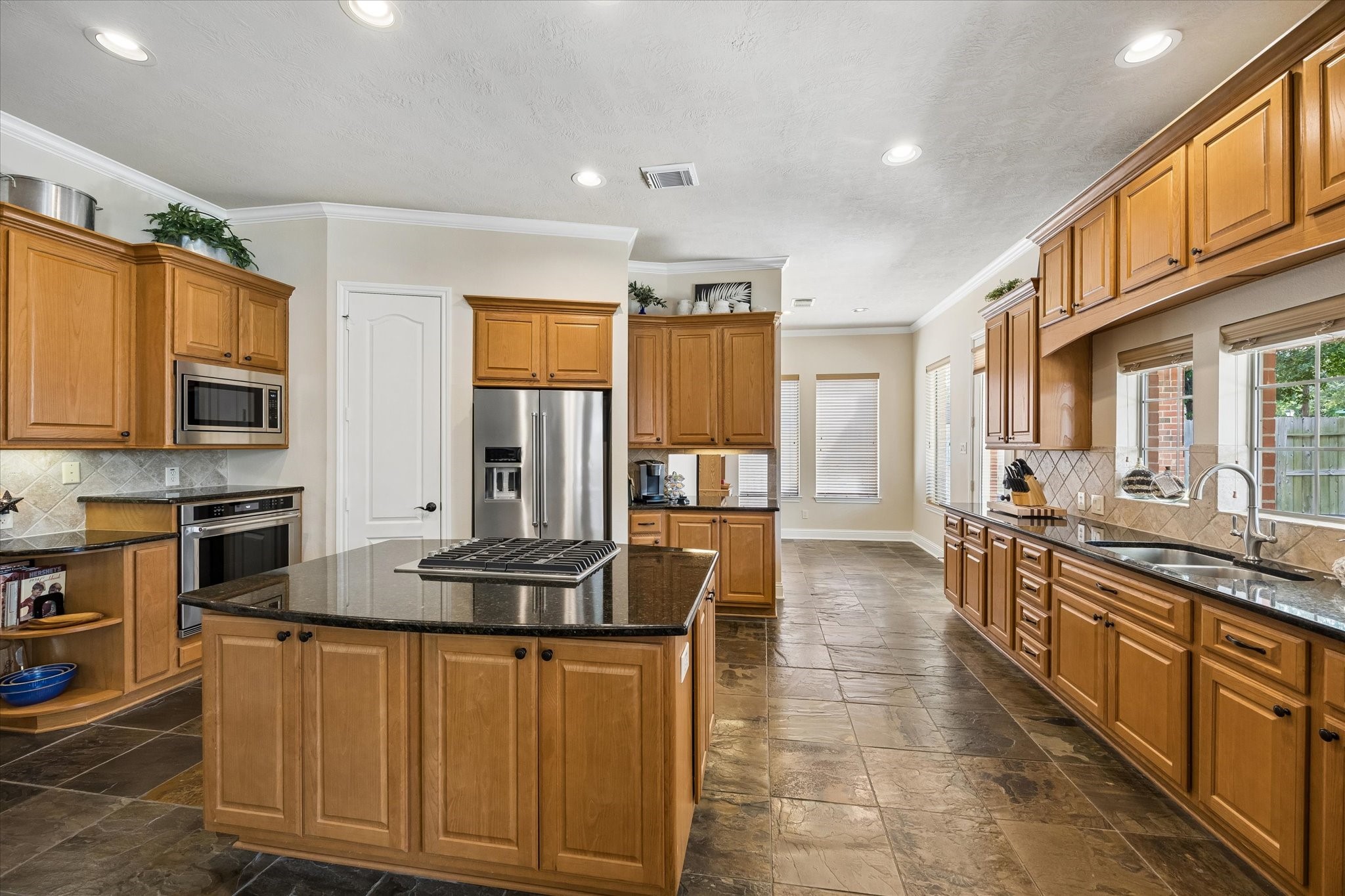 3902 Trailstone Lane Katy, TX 77494 - Photo 16 of 50 Bring your favorite recipes and all of your favorite people because this kitchen has the space to handle both, with extensive granite counters, abundant cabinetry, stainless-steel appliances, and room to spread out, cook, serve, and gather.