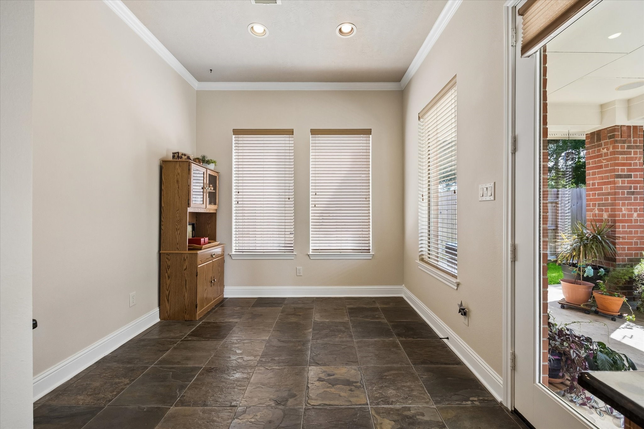 3902 Trailstone Lane Katy, TX 77494 - Photo 17 of 50 This casual dining area keeps everyday living easy with slate tile flooring, recessed lighting, and direct access to the patio and pool, so grabbing a quick breakfast or heading outside for dinner and drinks feels completely effortless.