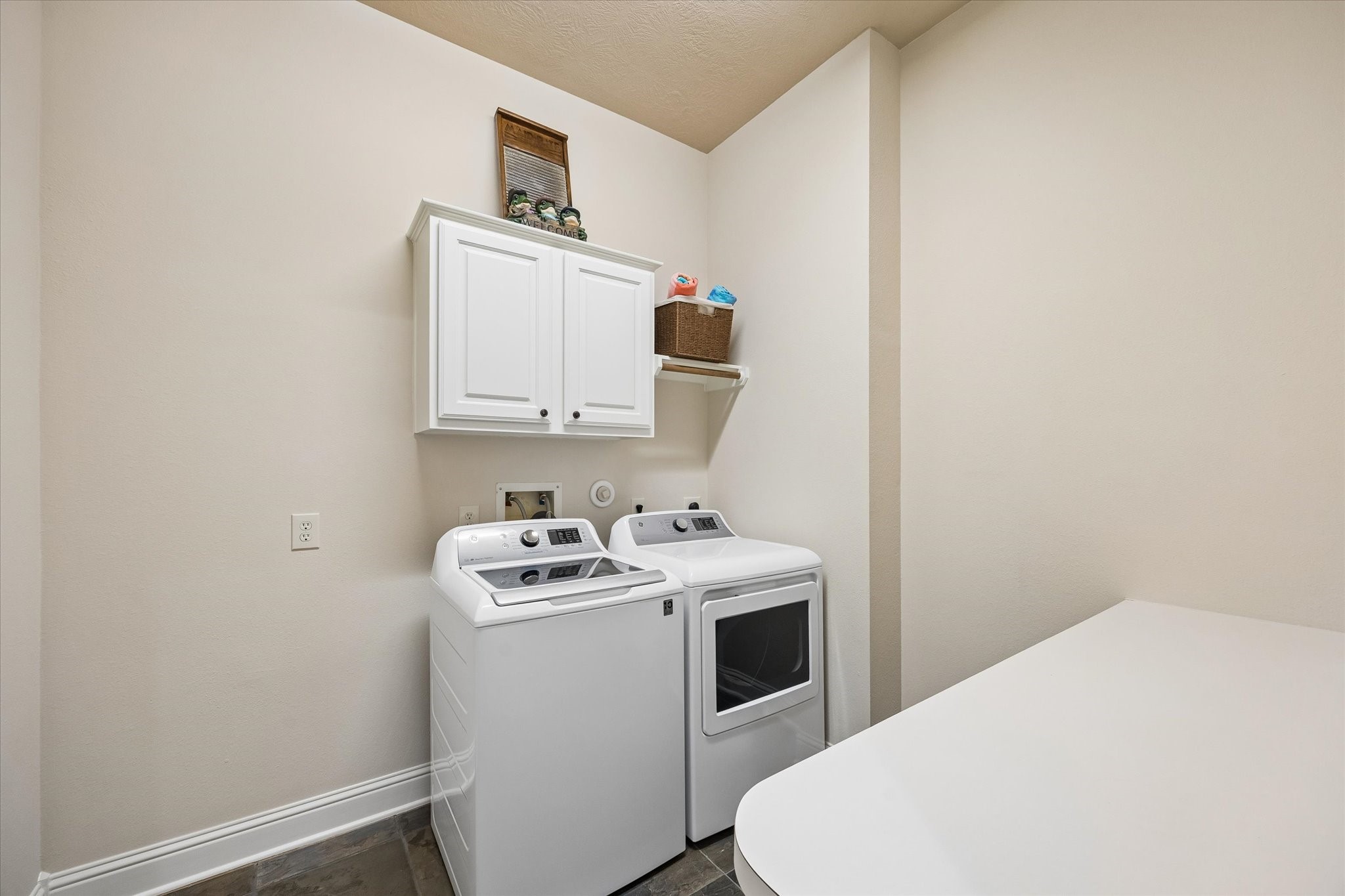 3902 Trailstone Lane Katy, TX 77494 - Photo 18 of 50 Laundry day feels a little easier here with upper cabinet storage, space to sort and fold, and a clean, functional layout that helps keep household chores running smoothly.