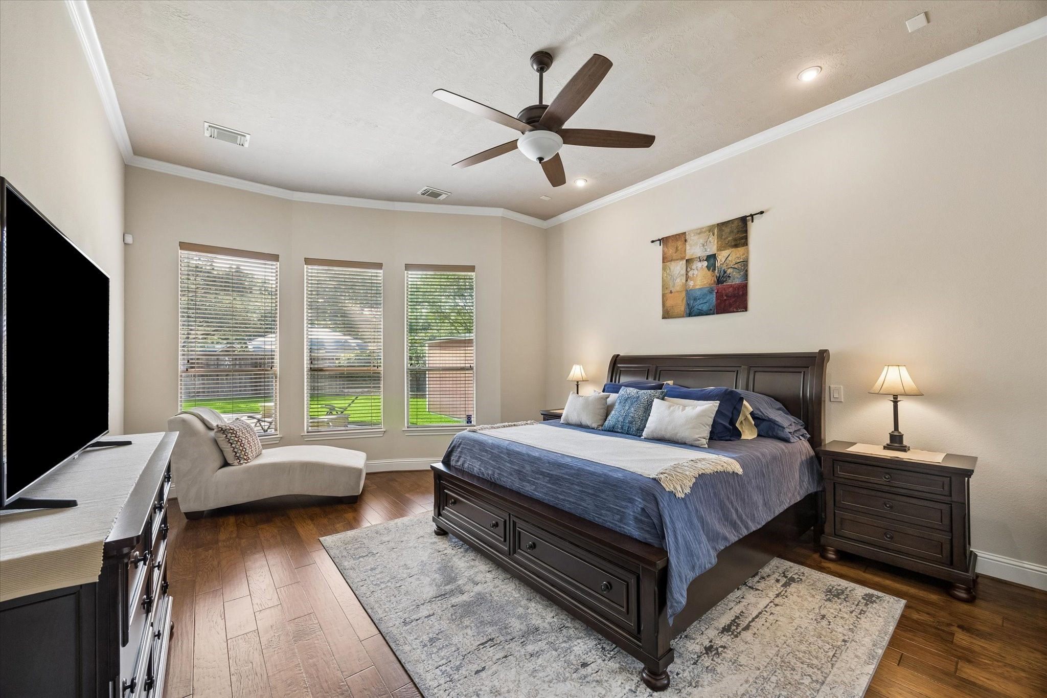 3902 Trailstone Lane Katy, TX 77494 - Photo 21 of 50 The owner’s suite is a spacious retreat with designer paint, rich engineered wood flooring, crown molding, a modern fan, and plenty of room to stretch out, unwind, and begin and end the day in complete comfort.