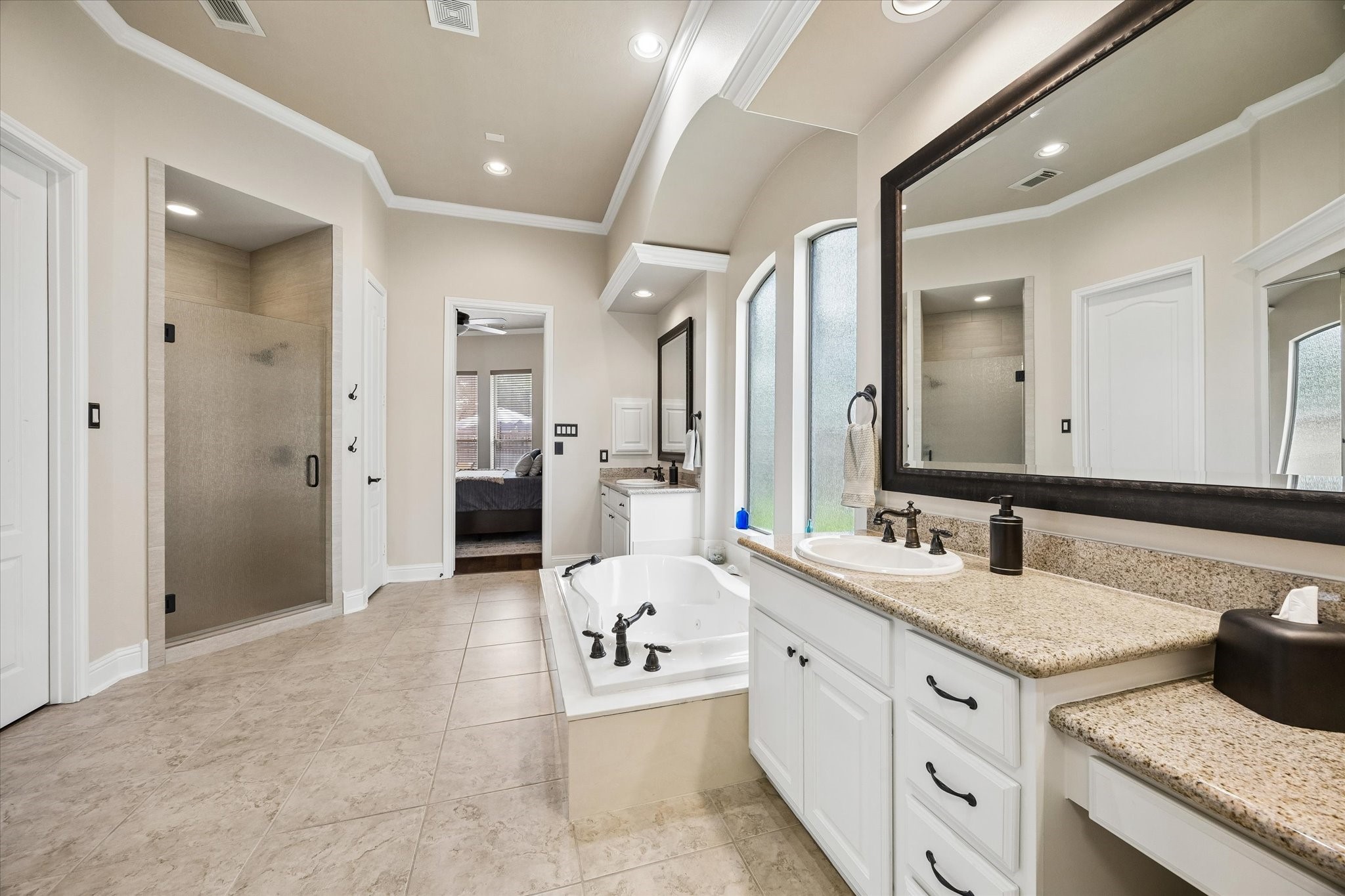 3902 Trailstone Lane Katy, TX 77494 - Photo 24 of 50 Start and end the day in a luxurious ensuite with dual vanities, a dedicated makeup station, a jetted soaking tub, walk-in shower and all the space you need to make busy mornings feel easy.