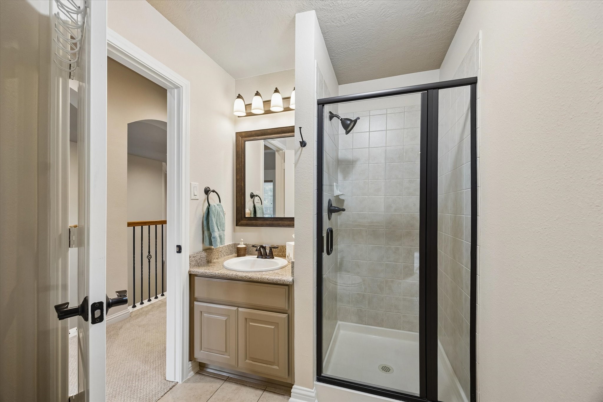 3902 Trailstone Lane Katy, TX 77494 - Photo 29 of 50 This full upstairs bathroom offers a single sink vanity and a walk-in shower. Clean, simple, and ready to help everyone start the day with ease.