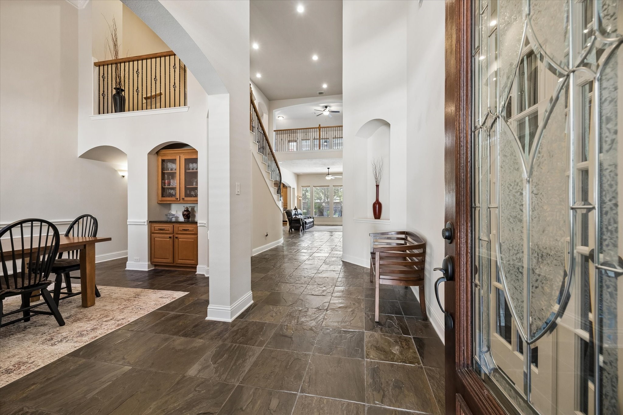 3902 Trailstone Lane Katy, TX 77494 - Photo 5 of 50 Open this door to luxurious living with soaring ceilings, chic lighting and fans, slate tile flooring, elegant arched doorways, neutral finishes, and all the space you need for comfortable daily living and unforgettable entertaining.
