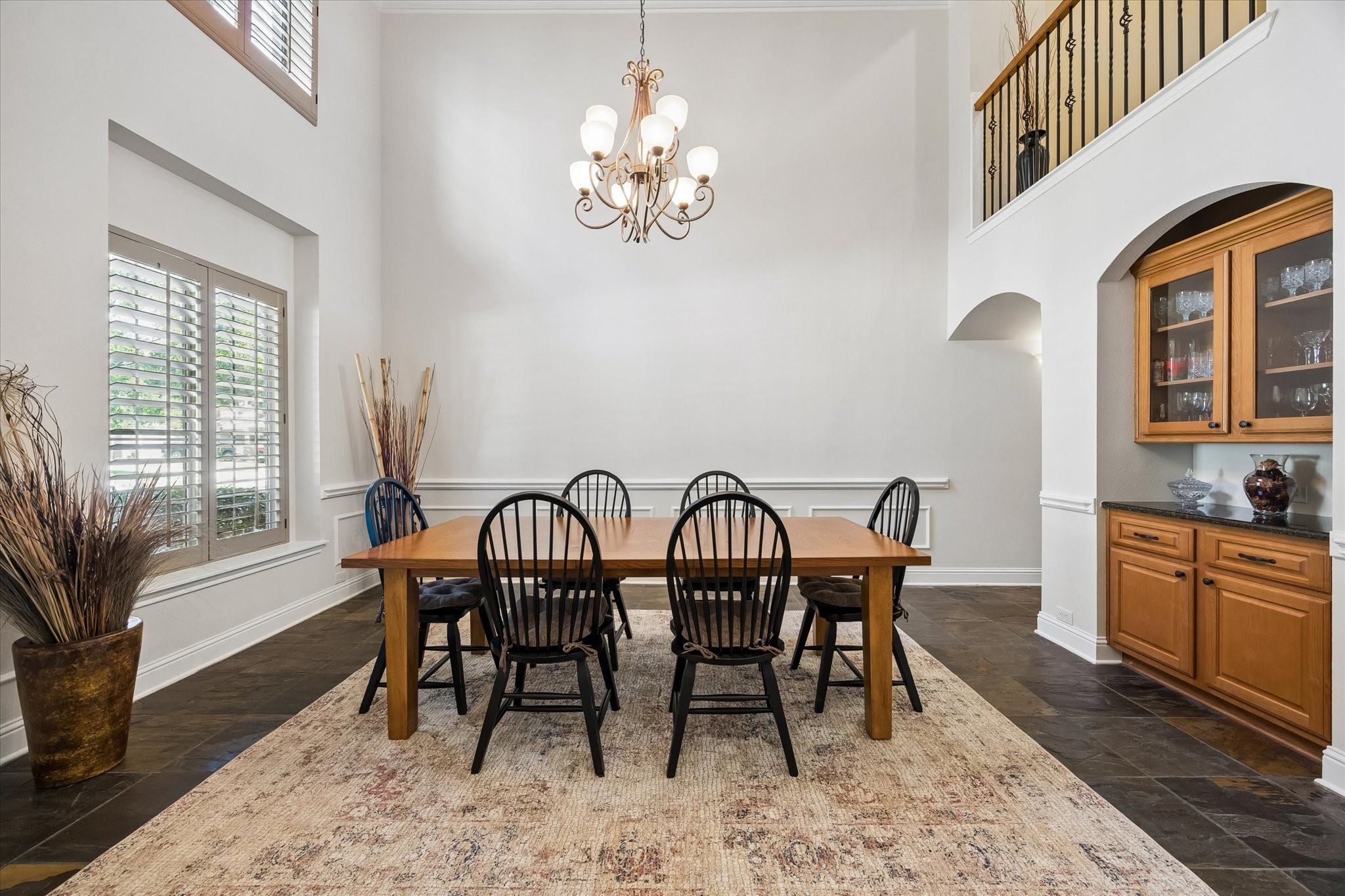 3902 Trailstone Lane Katy, TX 77494 - Photo 7 of 50 Gather them around your table in this dramatic formal dining room, where soaring ceilings, slate flooring, crown molding, and a chic chandelier create a stunning setting for holiday meals and unforgettable celebrations.
