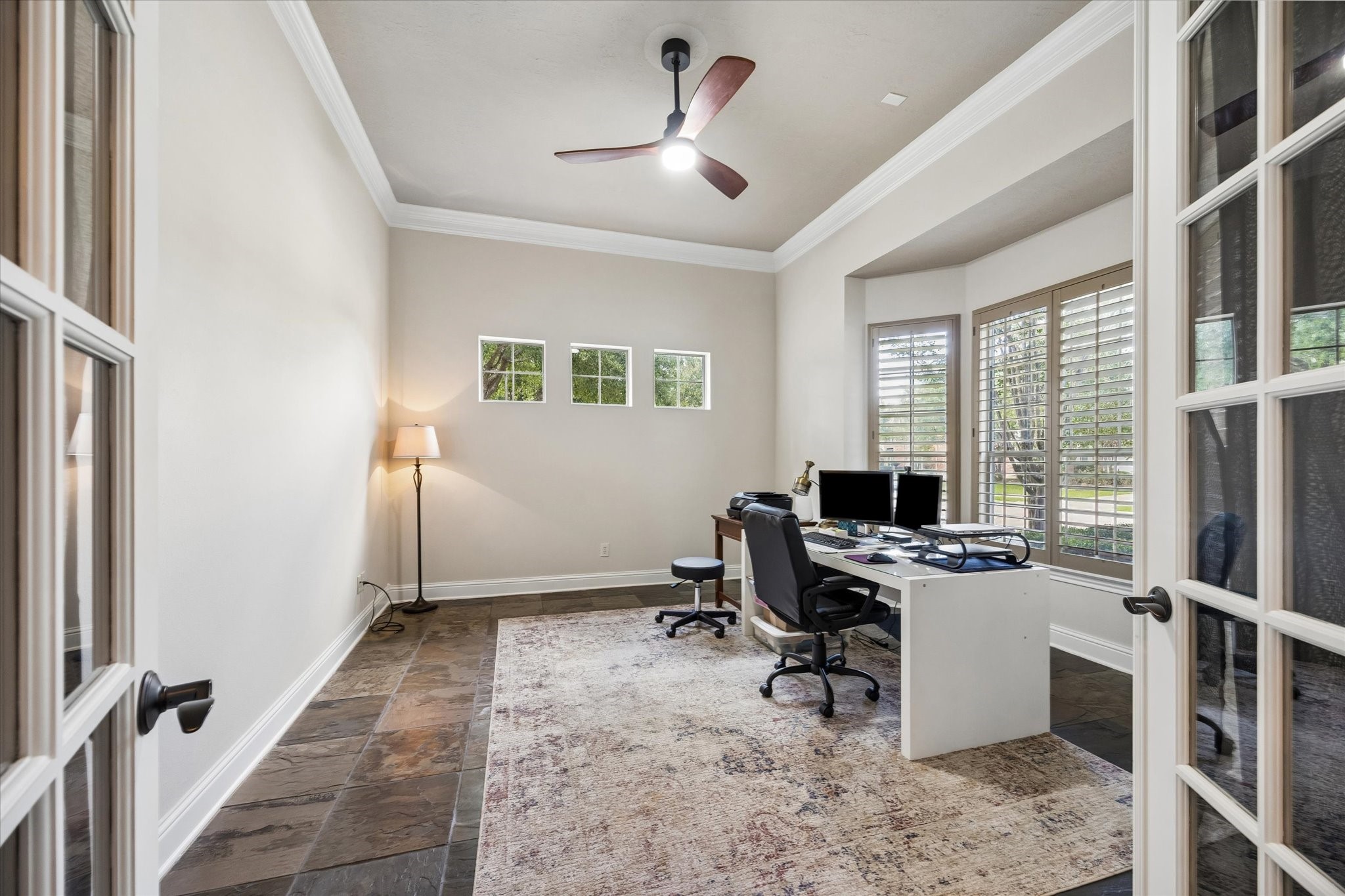 3902 Trailstone Lane Katy, TX 77494 - Photo 10 of 50 You’re going to love the morning commute to this handsome home office, complete with slate flooring, crown molding, a modern fan, and a wall of wood-shuttered windows that keeps the space feeling bright, open, and ready for the day.