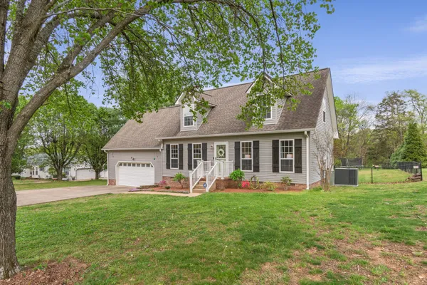 a view of a house with a yard balcony and sitting area