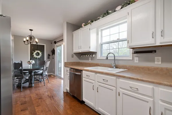 a view of a dining room with furniture and chandelier