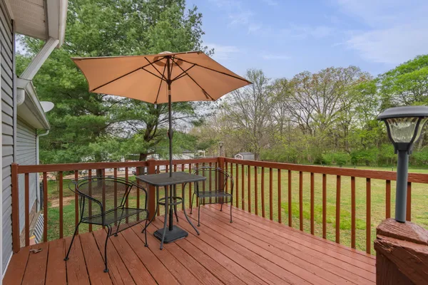 a view of outdoor space with deck and yard